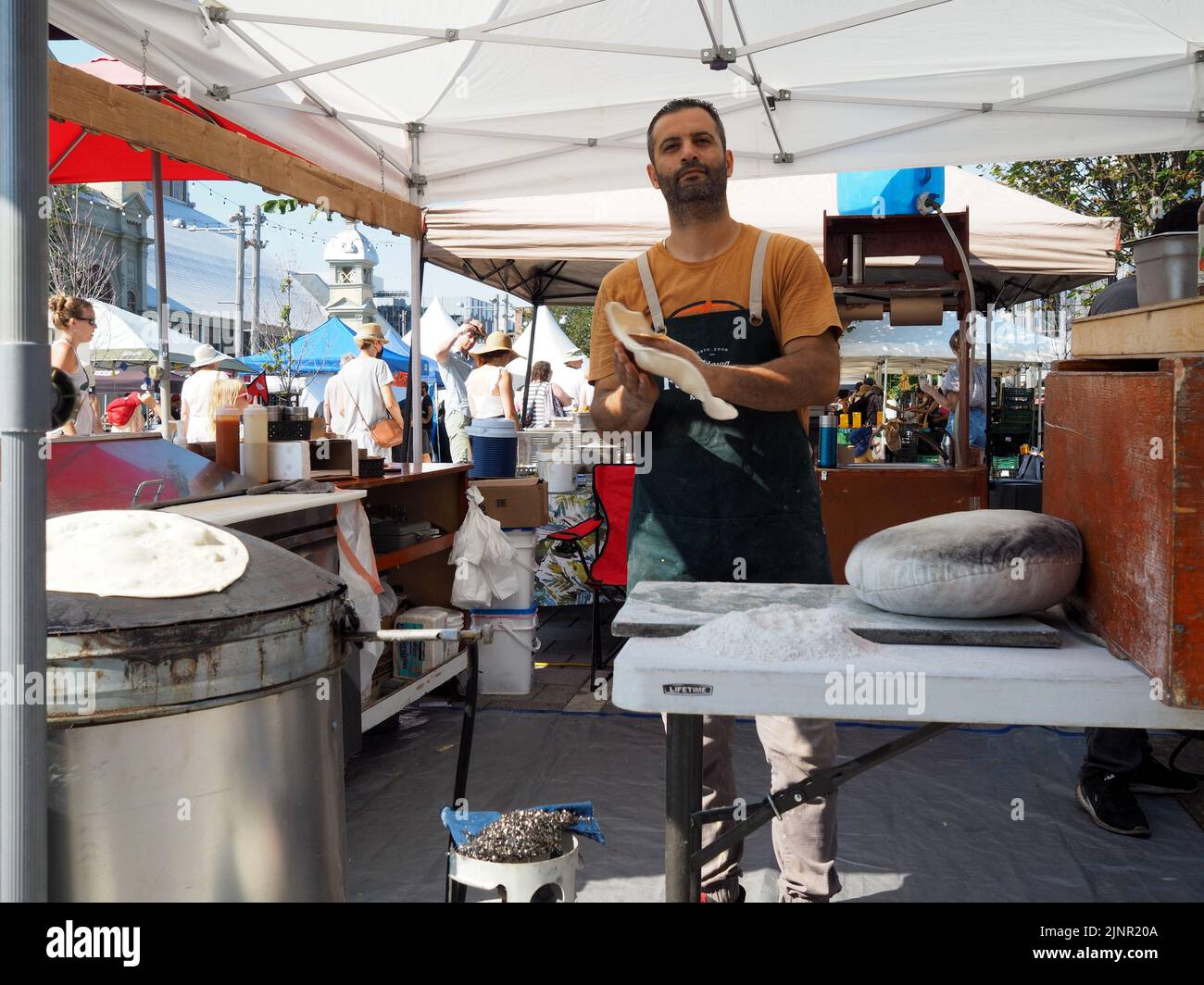 Scenes from the Farmer's Market at Lansdowne Place. Falafel Guys tossing pita dough. Ottawa, ON, Canada. Stock Photo