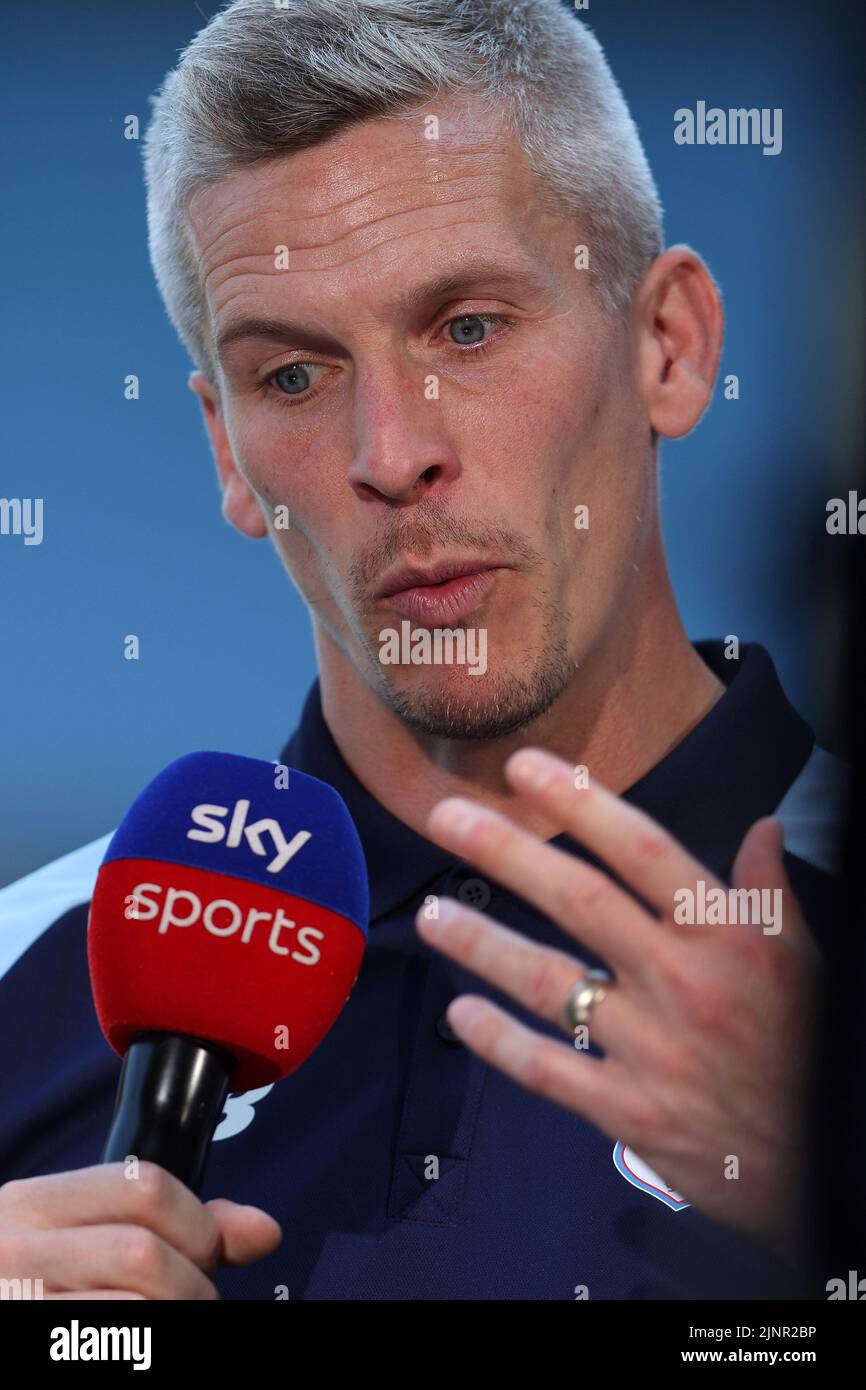 Cardiff, UK. 13th Aug, 2022. Steve Morison, the manager of Cardiff city looks on while interviewed by SKY Sports TV. EFL Skybet championship match, Cardiff city v Birmingham City at the Cardiff City Stadium in Cardiff, Wales on Saturday 13th August 2022. this image may only be used for Editorial purposes. Editorial use only, license required for commercial use. No use in betting, games or a single club/league/player publications. pic by Andrew Orchard/Andrew Orchard sports photography/Alamy Live news Credit: Andrew Orchard sports photography/Alamy Live News Stock Photo