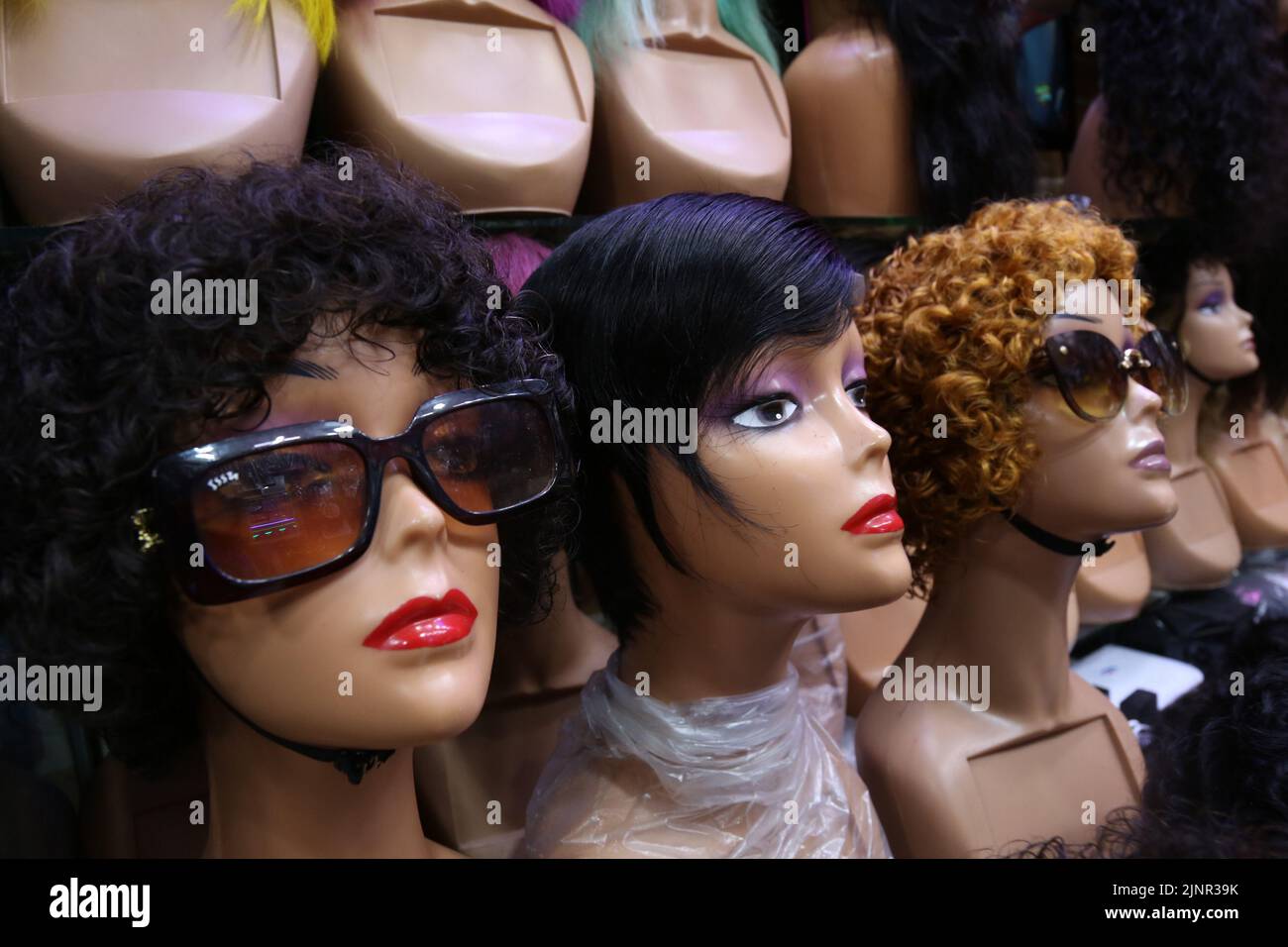 Dar Es Salaam, Tanzania. 13th Aug, 2022. Wigs are displayed at a shop in Dar es Salaam, Tanzania, on Aug. 13, 2022. TO GO WITH 'Feature: Human hair wigs find lucrative market in Tanzania' Credit: Herman Emmanuel/Xinhua/Alamy Live News Stock Photo