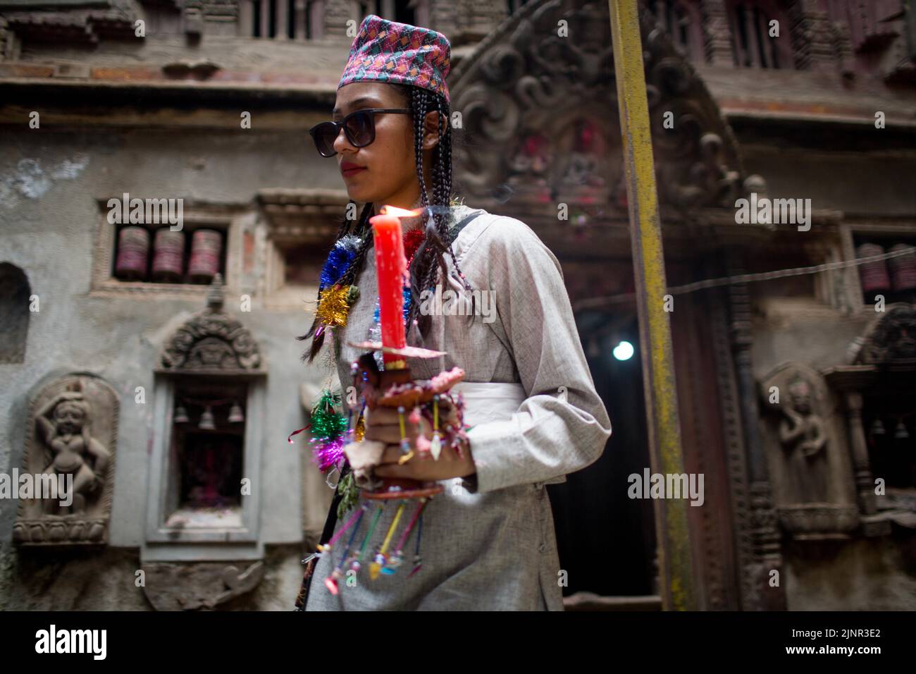 Lalitpur, Nepal. 13th Aug, 2022. A girl participates in a parade commemorating the Mataya festival, or the festival of lights, in Lalitpur, Nepal, Aug. 13, 2022. Credit: Sulav Shrestha/Xinhua/Alamy Live News Stock Photo