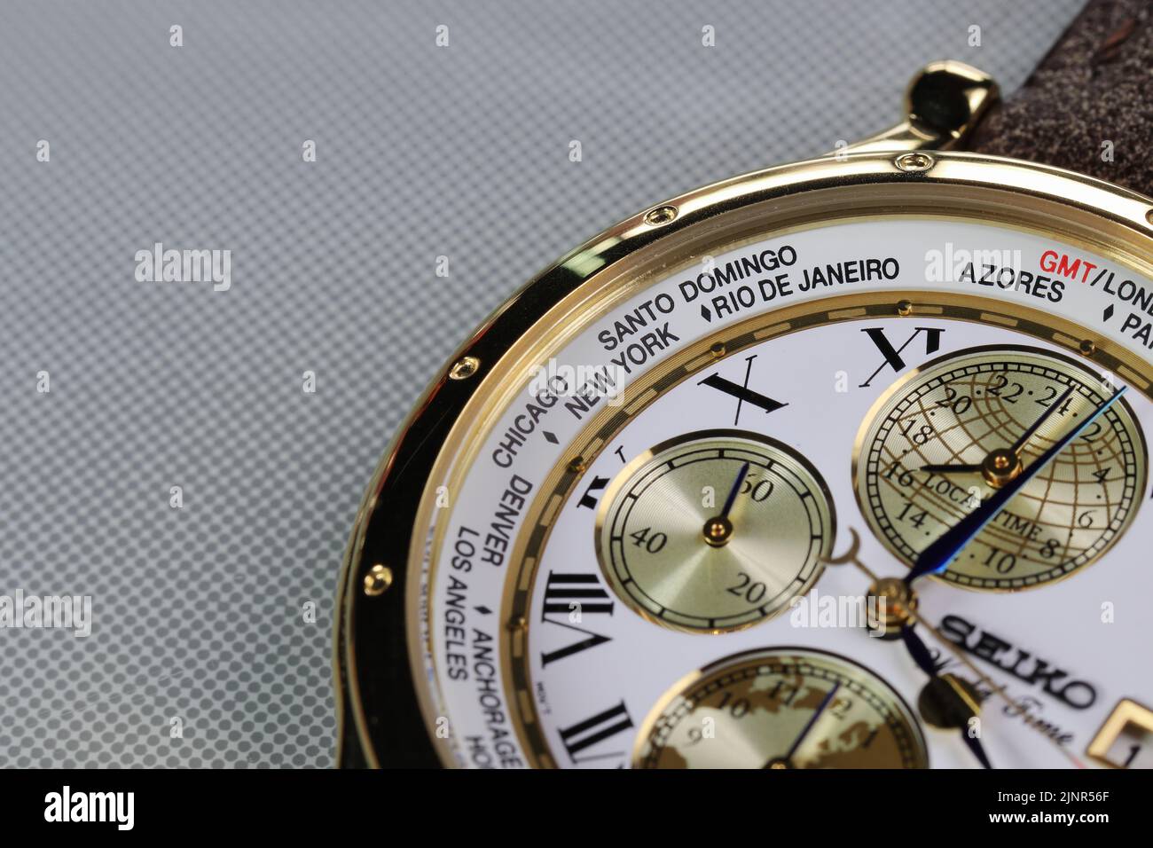 Close up on Time zone cities name on luxury world time watch bezel. Stock Photo