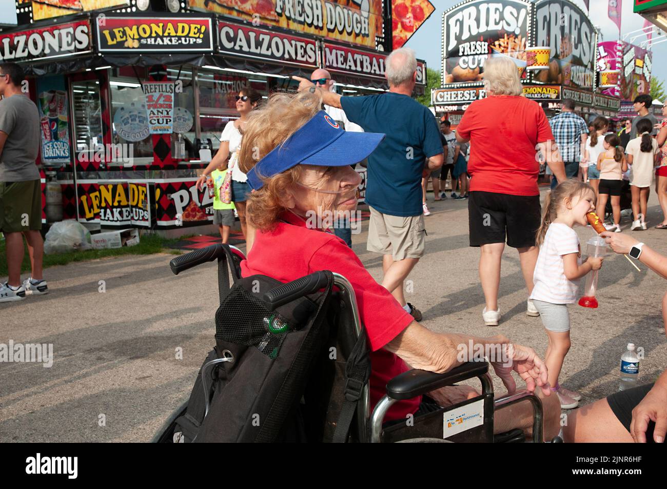 93 year old woman sitting in wheel chair at county fair. Stock Photo