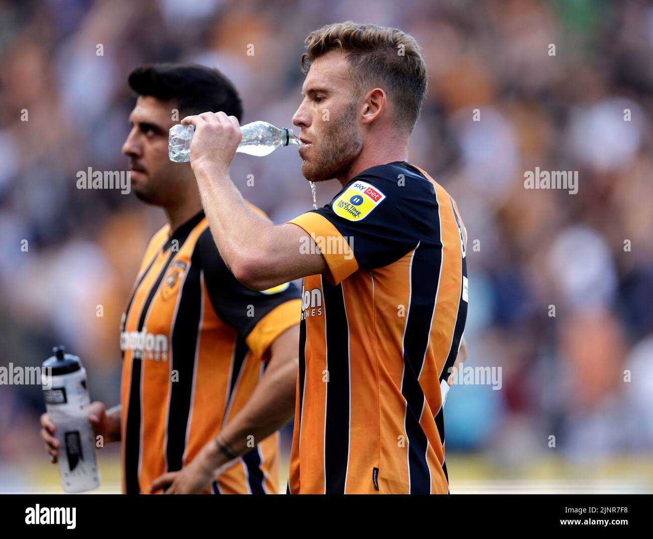 Hull City's Callum Elder drinks water from a bottle during a drinks break in the Sky Bet Championship match at the MKM Stadium, Hull. Picture date: Saturday August 13, 2022. Stock Photo
