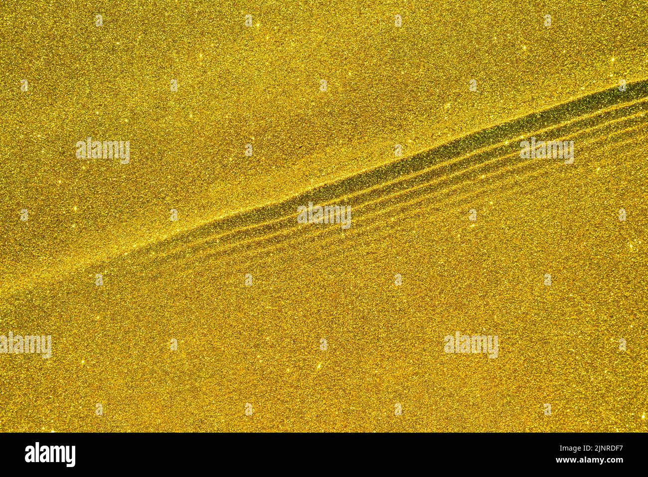 Golden sparkling backdrop with wave texture and water ripples, for premium advertising Stock Photo
