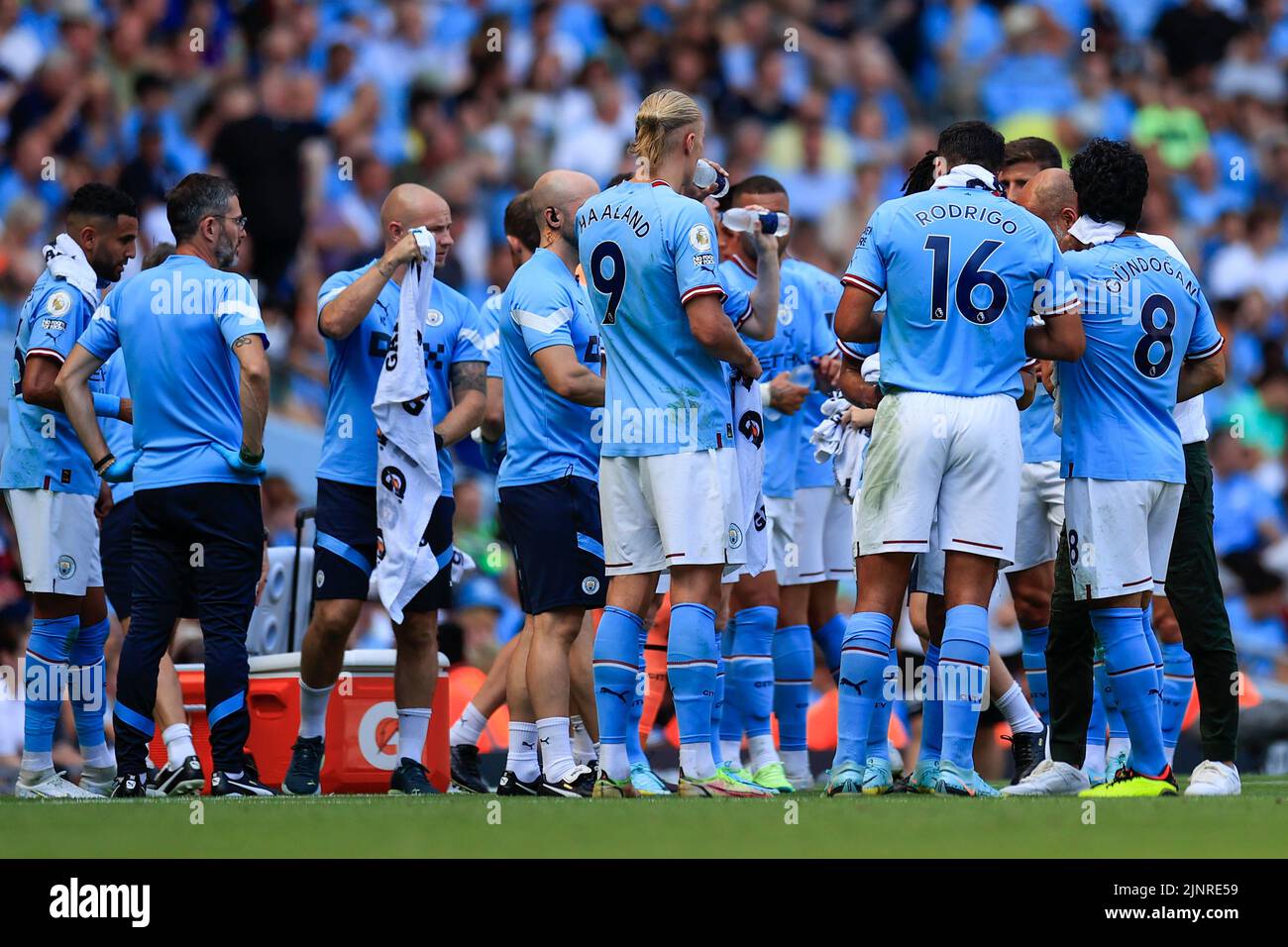 Manchester City players have a drinks break half way through the first half Stock Photo