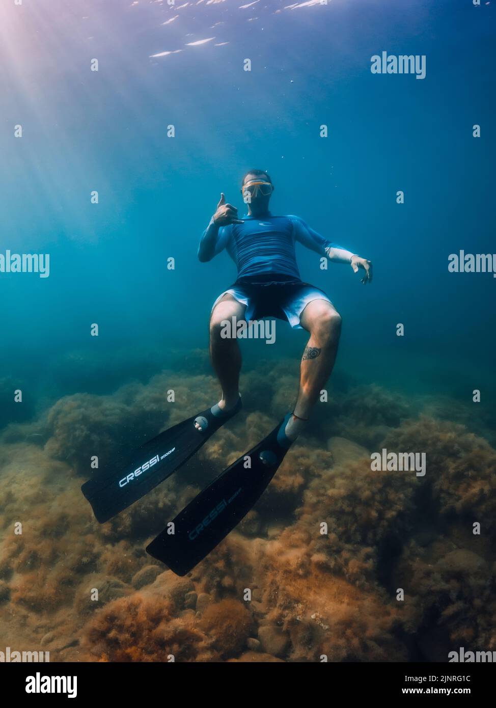 August 07, 2021. Varna, Bulgaria. Men freediver dive with fins in sea. Freediving underwater in transparent sea Stock Photo