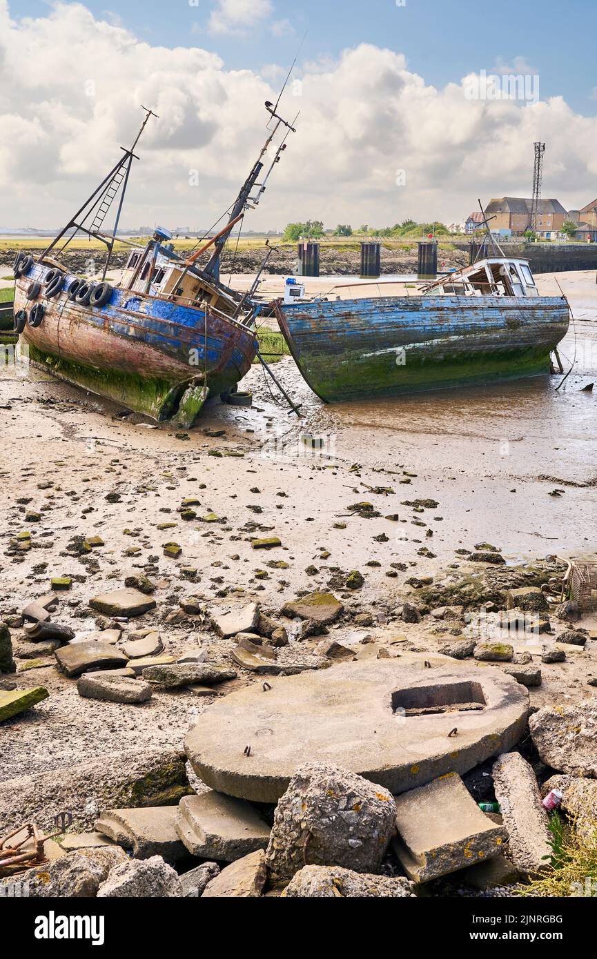Abandoned fishing vessels in Jubilee Dock,Fleetwood at low tide in summer Stock Photo