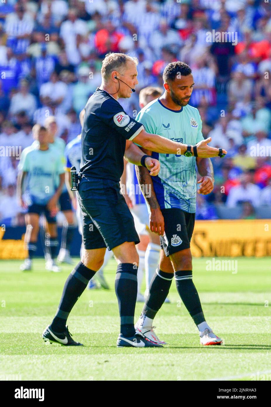 Brighton, UK. 13th Aug, 2022. Callum Wilson of Newcastle United is told to hurry up and leave the field by referee Graham Scott after he was substituted during the Premier League match between Brighton & Hove Albion and Newcastle United at The Amex on August 13th 2022 in Brighton, England. (Photo by Jeff Mood/phcimages.com) Credit: PHC Images/Alamy Live News Stock Photo