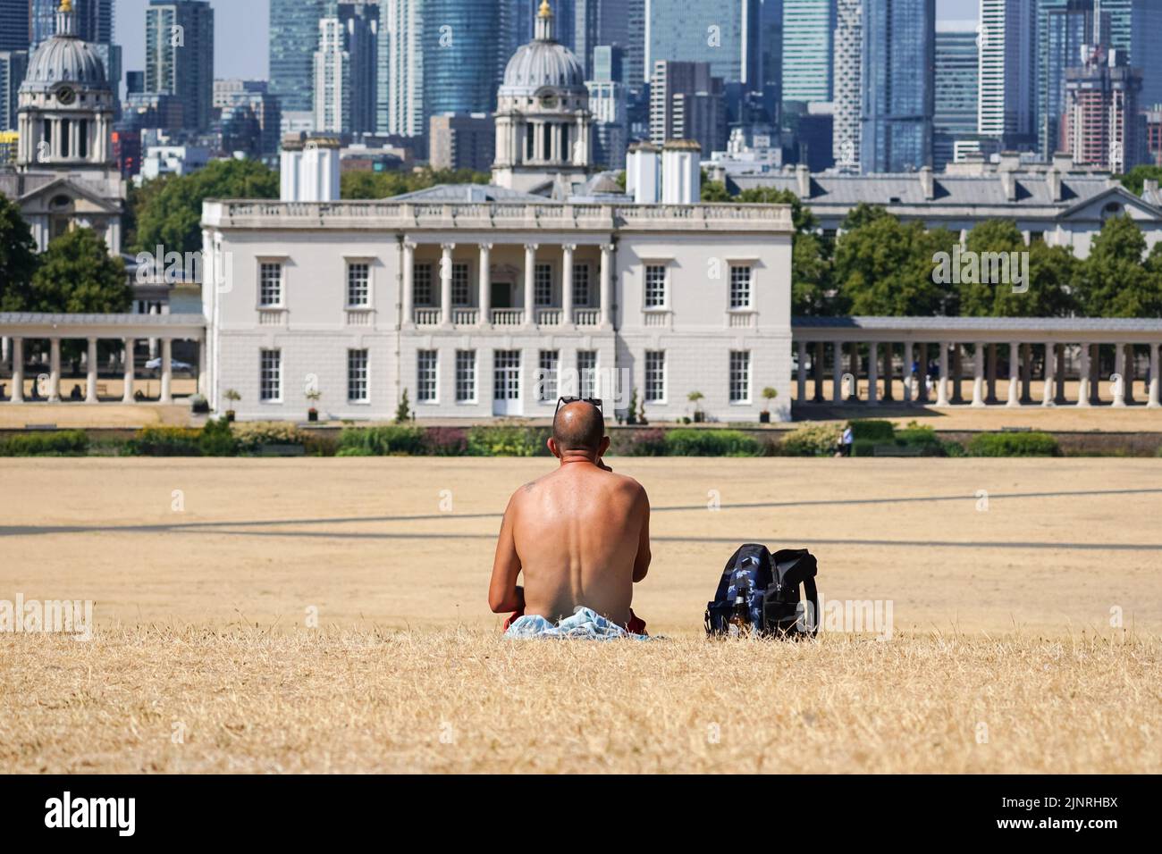 London, UK. 13th Aug, 2022. UK Weather: A man sits in a dry Greenwich park in London. Credit: Marcin Rogozinski/Alamy Live News Stock Photo