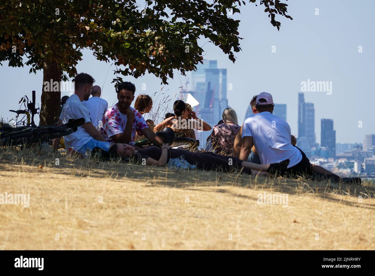 London, UK. 13th Aug, 2022. UK Weather: People hide from the sun in Greenwich park during heatwave. Credit: Marcin Rogozinski/Alamy Live News Stock Photo