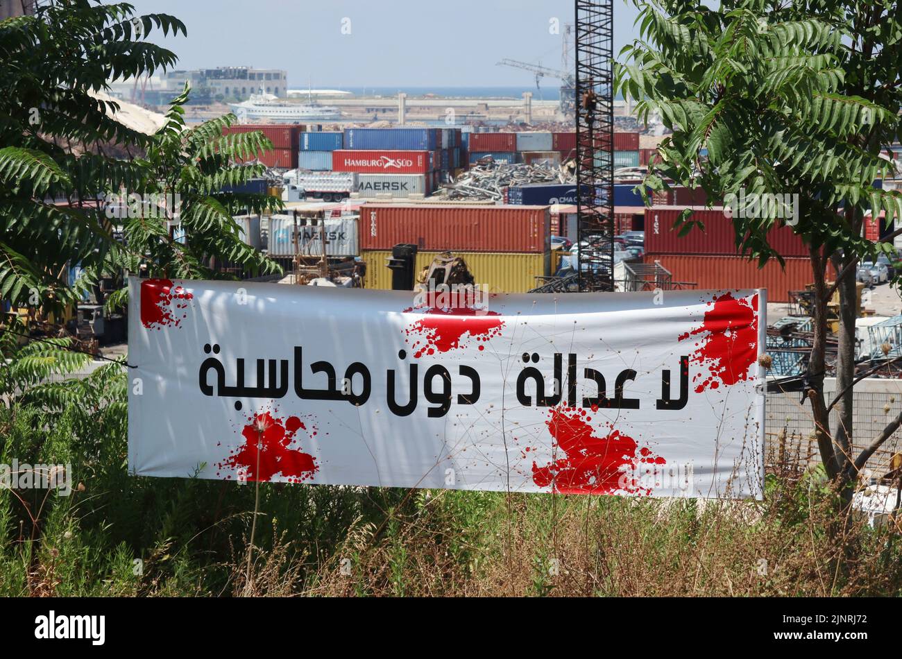 Banner set by activists at the port to mark the second anniversary of explosion, seen in Beirut, Lebanon, August 10 2022.  (Photo by Elisa Gestri/Sipa USA). Stock Photo