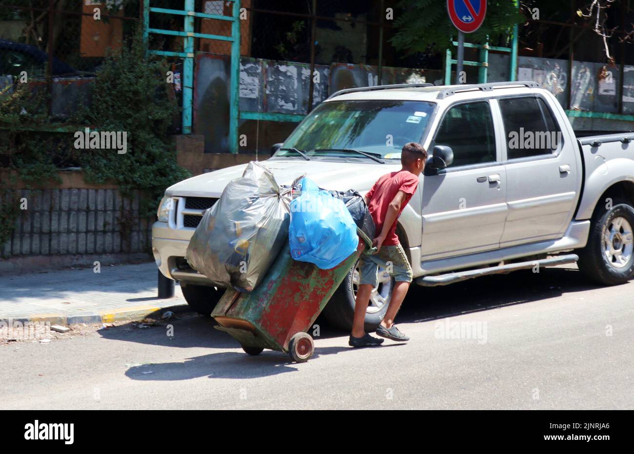 Syrian child at work for illegal waste trade seen in a street of Beirut, Lebanon, on August 11 2022.  (Photo by Elisa Gestri/Sipa USA). Stock Photo