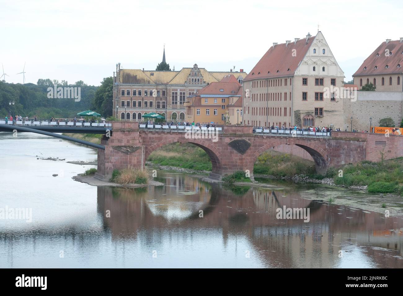 Grimma, Germany. 13th Aug, 2022. View of the Pöppelmann Bridge and the city center. A celebration was held in Grimma on Saturday to mark the completion of the flood protection system. The city was particularly hard hit by the floods in August 2002. Credit: Sebastian Willnow/dpa/Alamy Live News Stock Photo