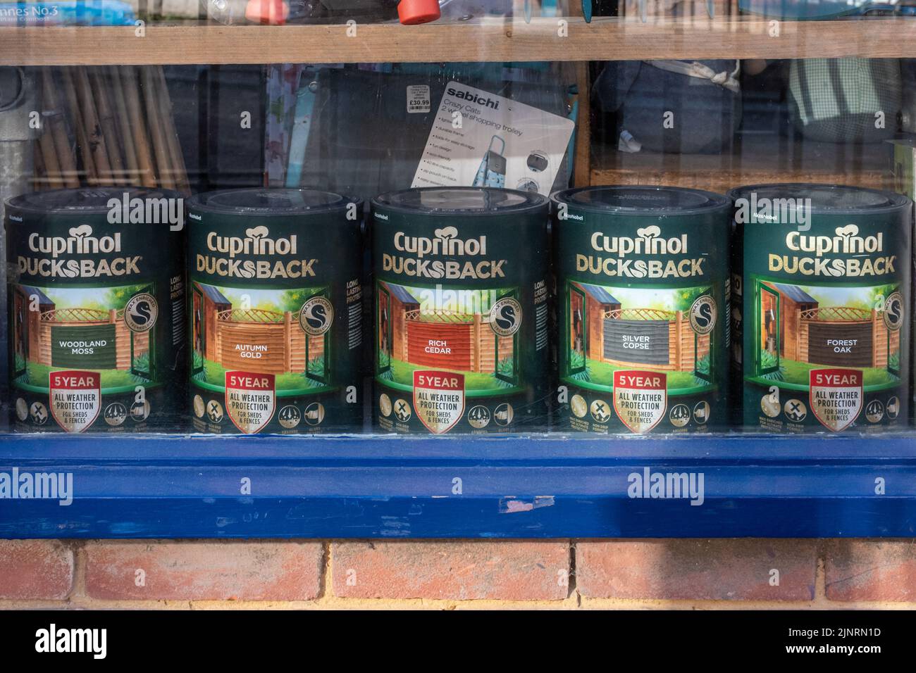 Cuprinol Ducksback, tins of wood stain in a shop window, England, UK Stock Photo