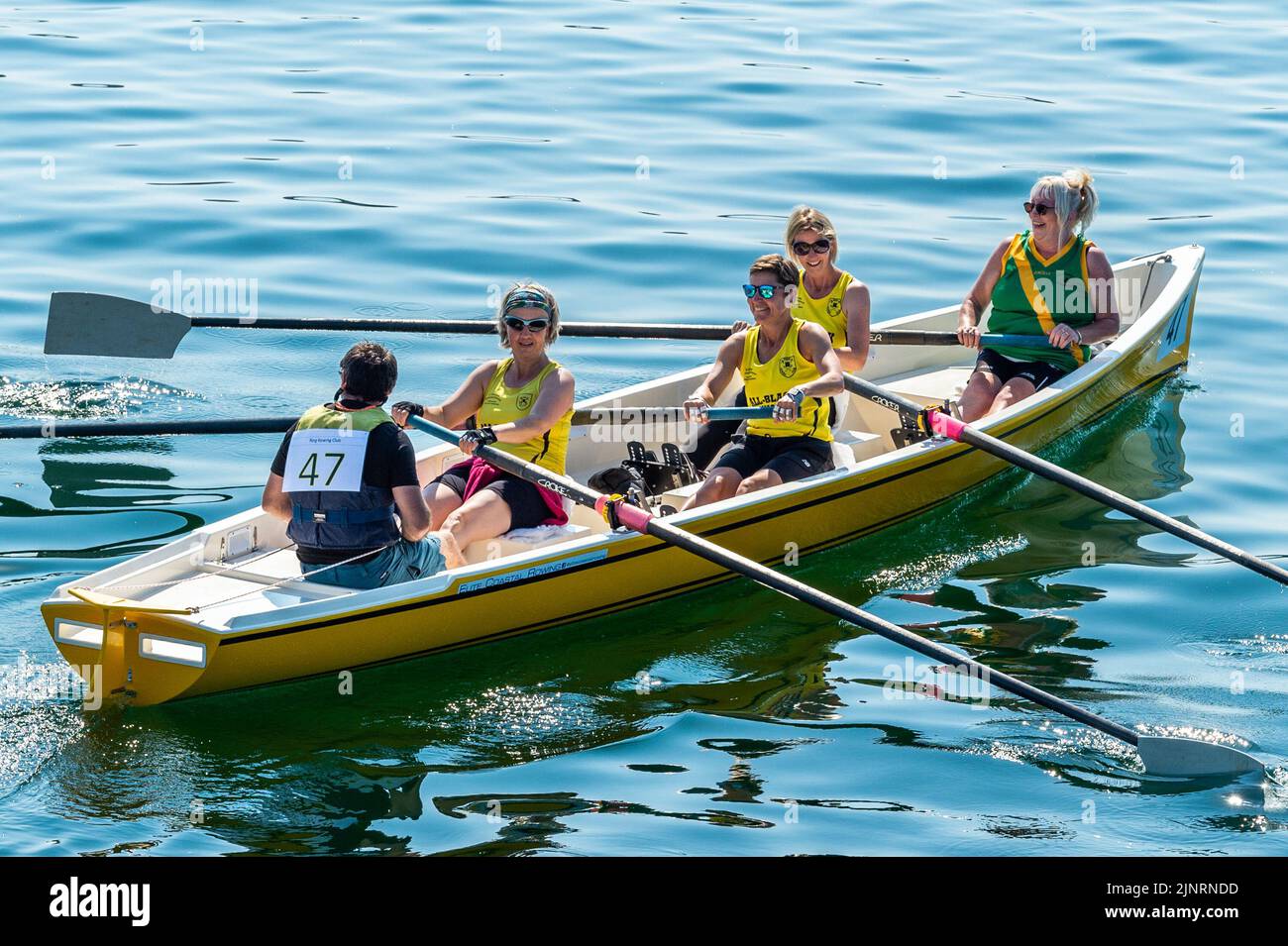 Schull, West Cork, Ireland. 13th Aug, 2022. The 2022 Irish Coastal Rowing Championships is taking place this weekend in Schull, West Cork. A total of 290 crews from different clubs are taking part in the event which finishes Sunday evening. Ring Rowing Club Ladies crew prepares to race. Credit: AG News/Alamy Live News Stock Photo