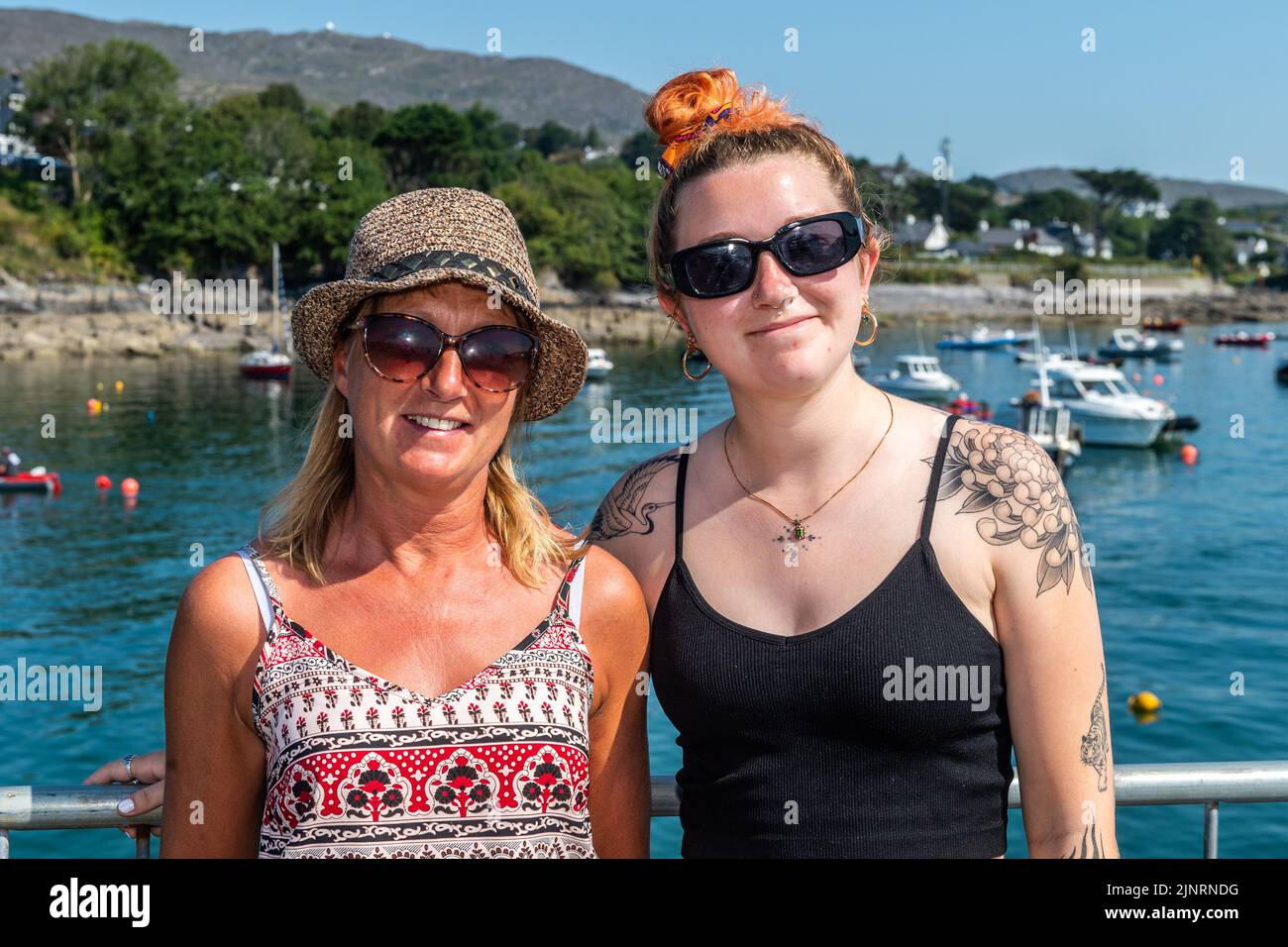 Schull, West Cork, Ireland. 13th Aug, 2022. The 2022 Irish Coastal Rowing Championships is taking place this weekend in Schull, West Cork. A total of 290 crews from different clubs are taking part in the event which finishes Sunday evening. Enjoying the event were Maggie and Zoe Fleury from Schull. Credit: AG News/Alamy Live News Stock Photo