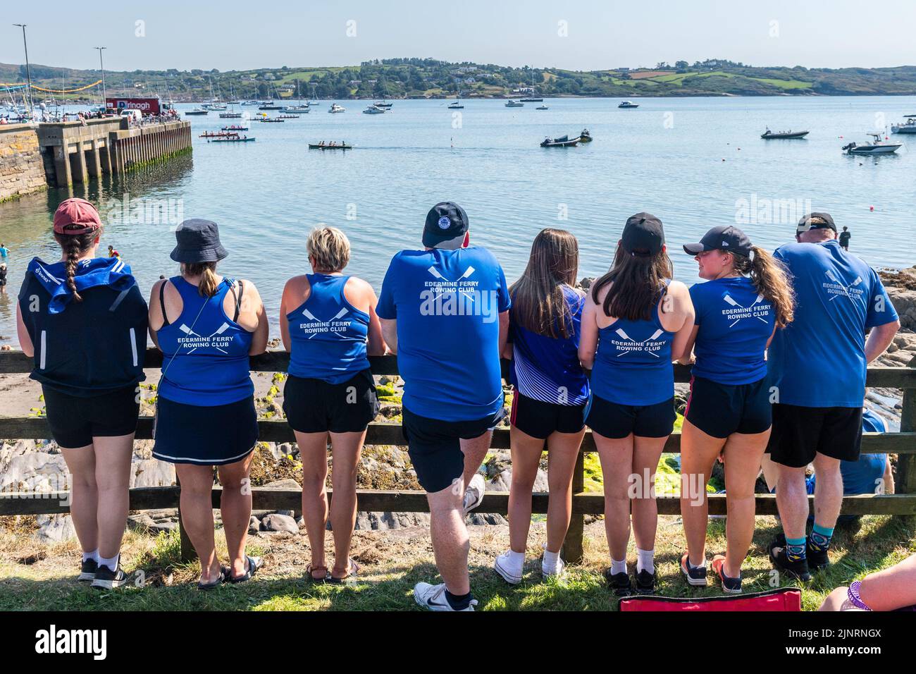 Schull, West Cork, Ireland. 13th Aug, 2022. The 2022 Irish Coastal Rowing Championships is taking place this weekend in Schull, West Cork. A total of 290 crews from different clubs are taking part in the event which finishes Sunday evening. Members of Edermine Ferry Rowing Club watch the action. Credit: AG News/Alamy Live News Stock Photo