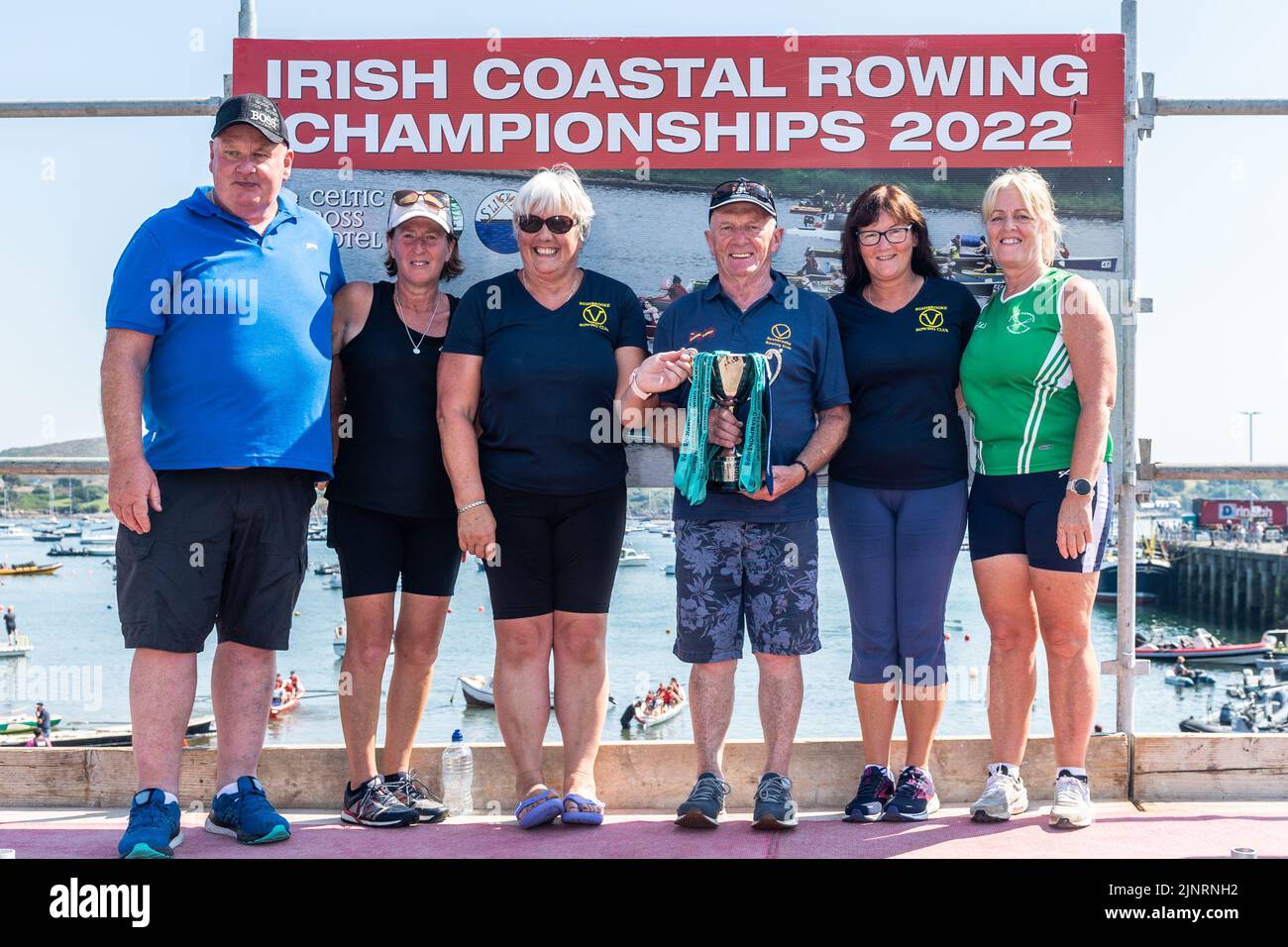 Schull, West Cork, Ireland. 13th Aug, 2022. The 2022 Irish Coastal Rowing Championships is taking place this weekend in Schull, West Cork. A total of 290 crews from different clubs are taking part in the event which finishes Sunday evening. Chairman of the regatta, Ted McSweeny, presents a trophy to Rushbrooke Rowing Club. Credit: AG News/Alamy Live News Stock Photo