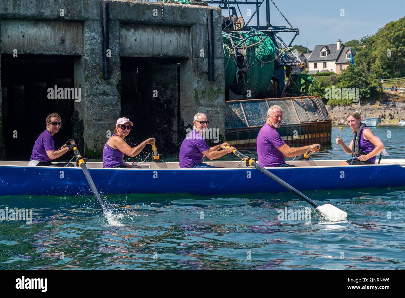 Schull, West Cork, Ireland. 13th Aug, 2022. The 2022 Irish Coastal Rowing Championships is taking place this weekend in Schull, West Cork. A total of 290 crews from different clubs are taking part in the event which finishes Sunday evening. Rosscarbery Rowing Club mixed crew warms down after a race. Credit: AG News/Alamy Live News Stock Photo