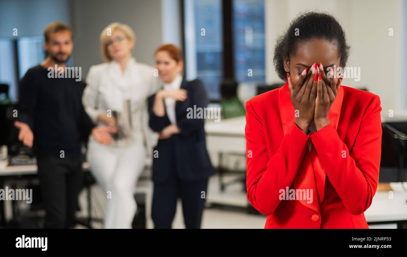 Redicale Young african woman crying because of the ridicule of colleagues ...