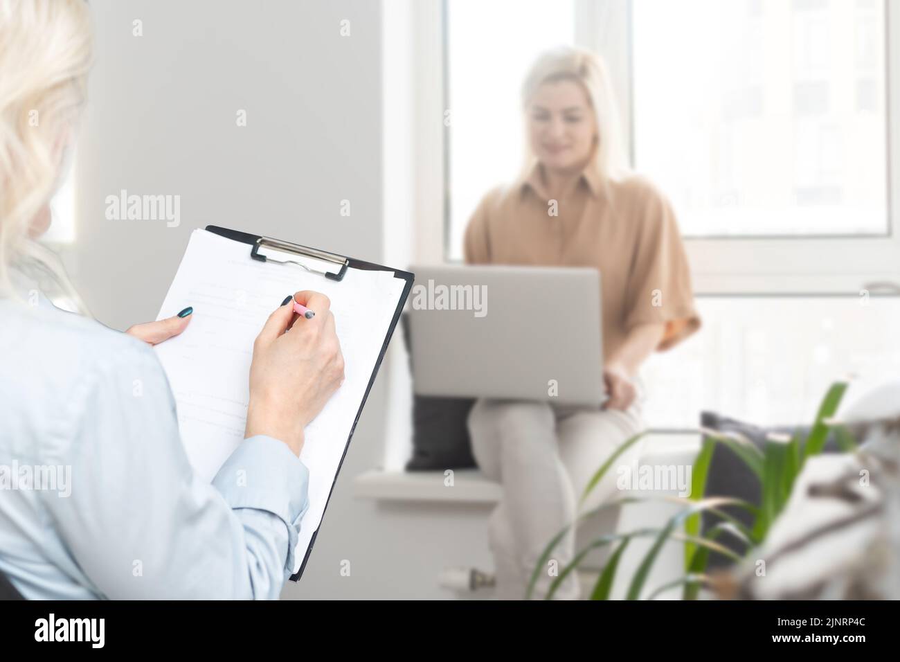 Young woman is using laptop for remote conversation with friend. People ...