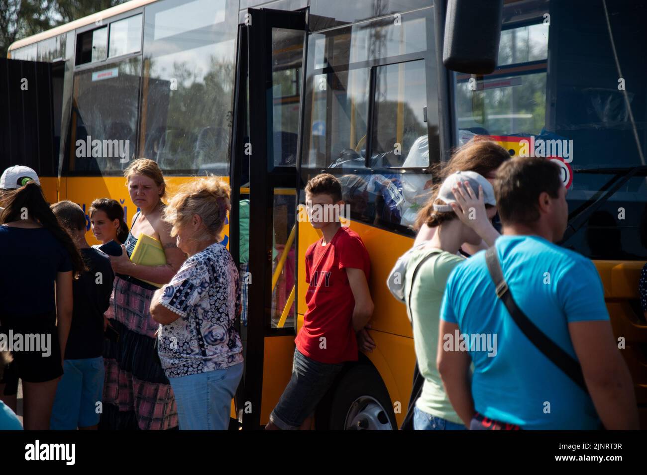 Fleeing the occupied town of Rozovka, a young boy waits near his evacuation bus in Zaporizhzhia. Since the start of the war the city of Zaporizhzhia has set up refugee centers across the city to help with the influx of those escaping the violence. Stock Photo