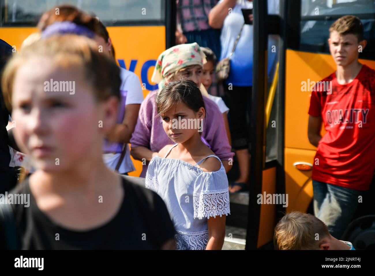 A young girl waits in Zaporizhzhia after evacuating from the occupied town of Rozovka. As the war continues, refugees continue to flee the violence of war. Stock Photo