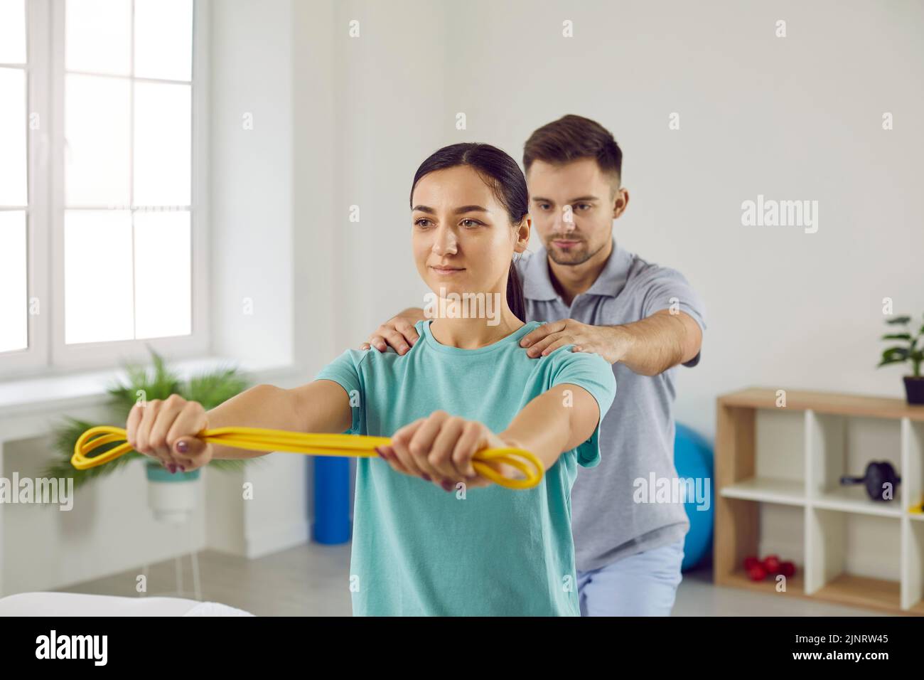Physiotherapist help female patient recover Stock Photo