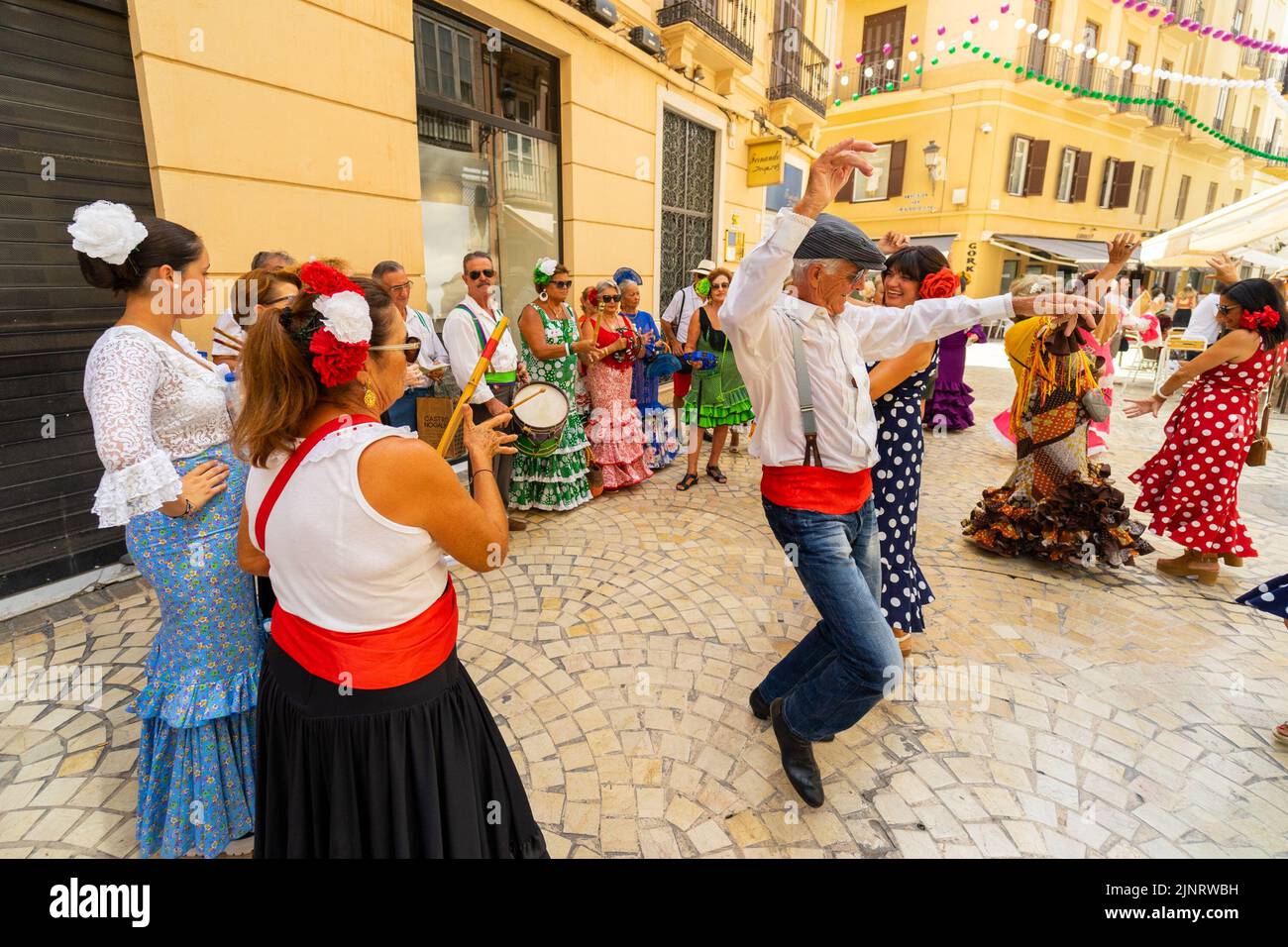 People seen dancing flamenco on the street during the first day of Malaga's Fair 2022. The Fair is being held for the first time since 2019. The 2020 and 2021 editions were suspended due to Covid19 pandemic. (Photo by Francis Gonzalez / SOPA Images/Sipa USA) Stock Photo