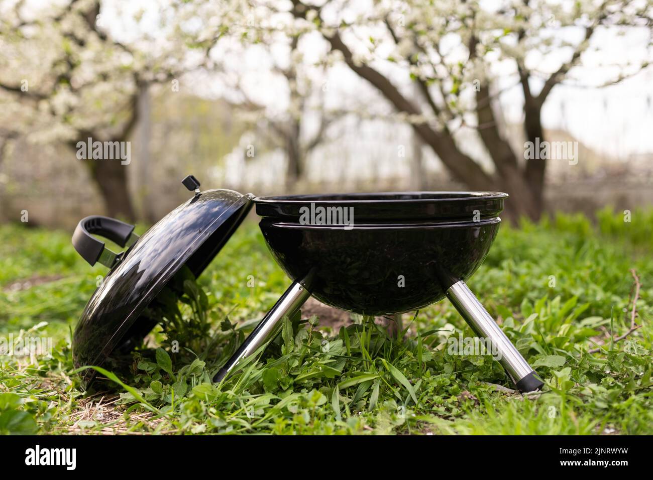 An empty barbecue grill stands in the yard Stock Photo - Alamy