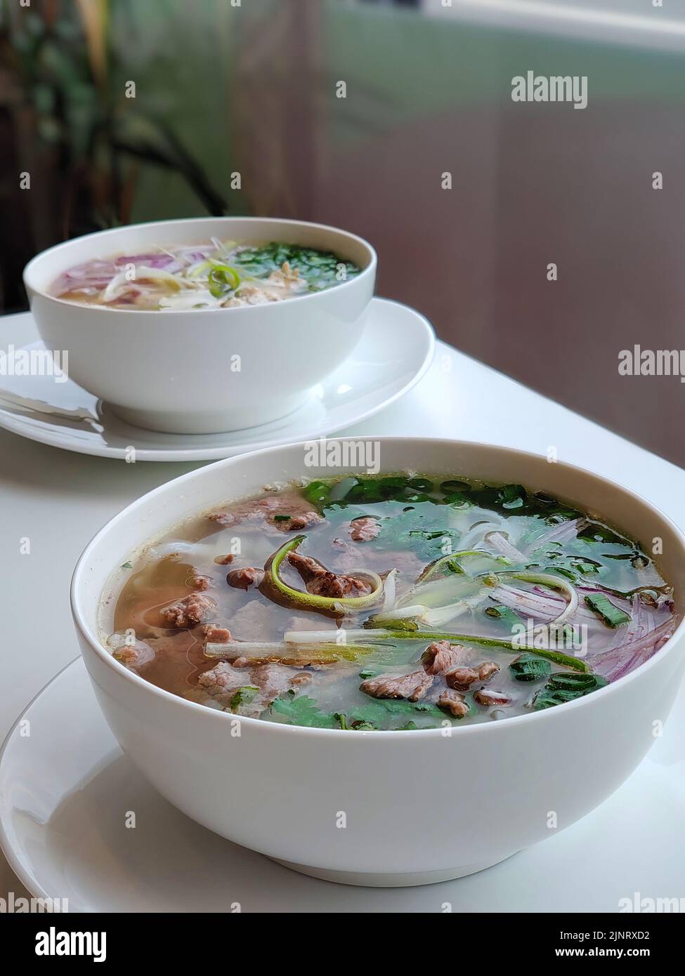 Two bowls of Pho Bo on table Stock Photo