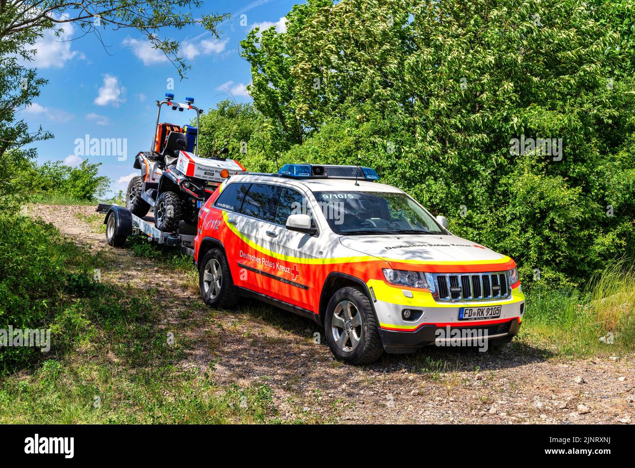 Emergency vehicle of DRK with an all terrain vehicle on the trailer Stock Photo