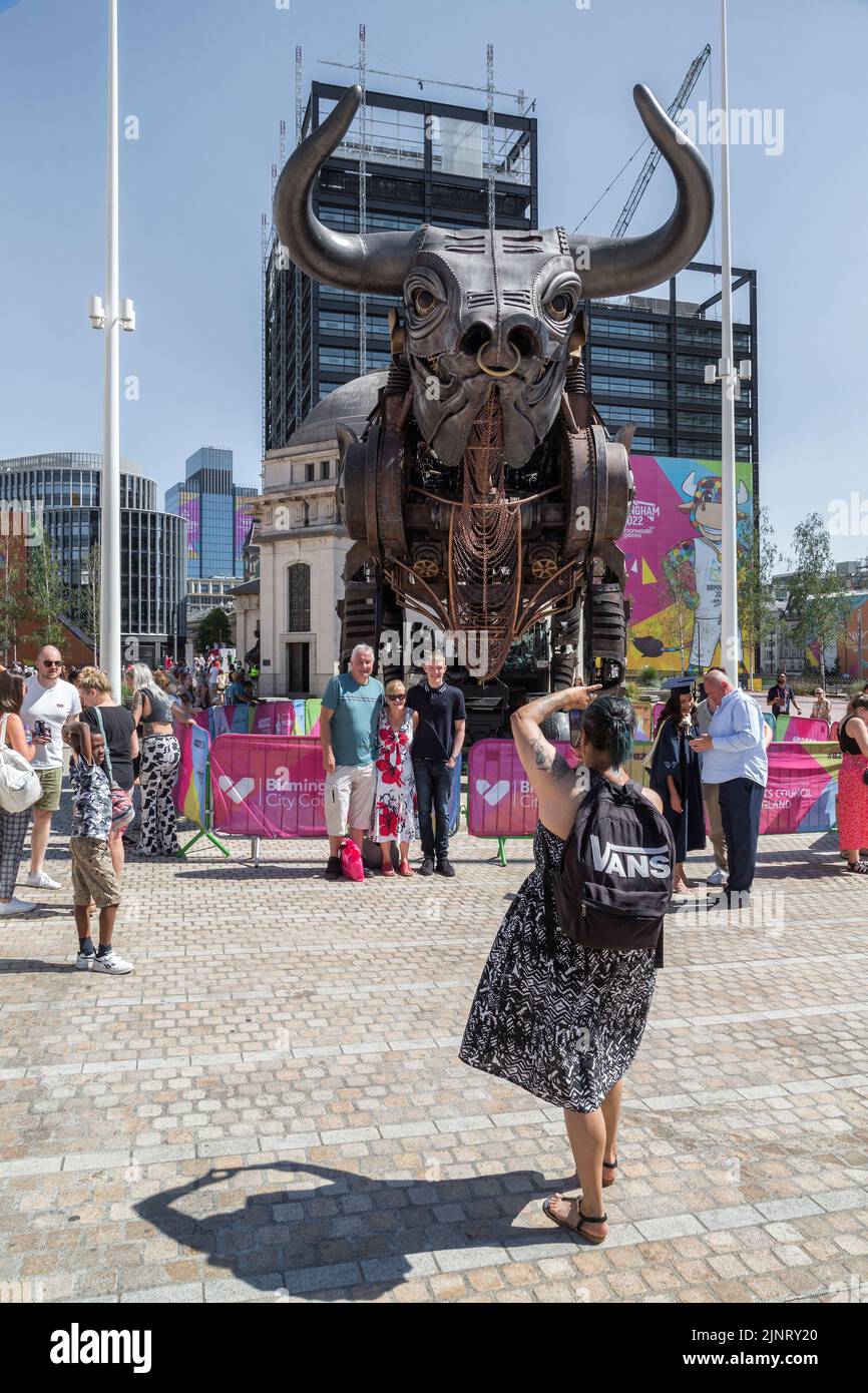 People having the picture taken next to the 10 metre high raging bull from the 2022 Commonwealth Games opening ceremony. Centenary Square, Birmingham, Stock Photo