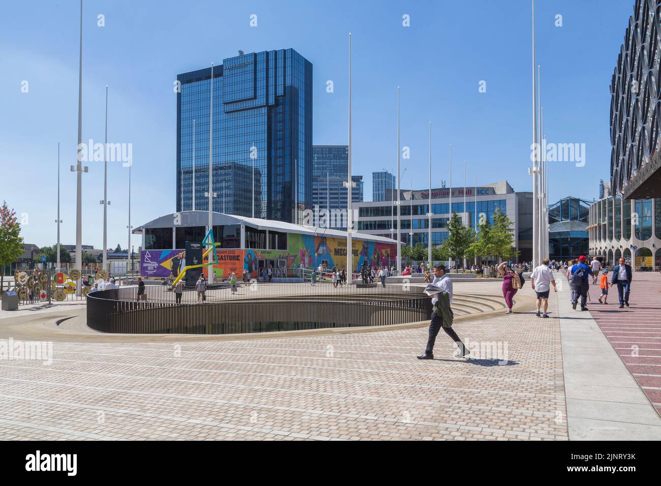 The Official Megastore for Birmingham 2022 Commonwealth Games adds a splash of colour to Centenary Square, as locals and tourists go about there day. Stock Photo