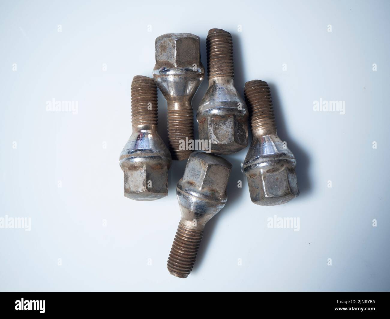 wheel bolts on a white background. Mechanical concept Stock Photo Alamy