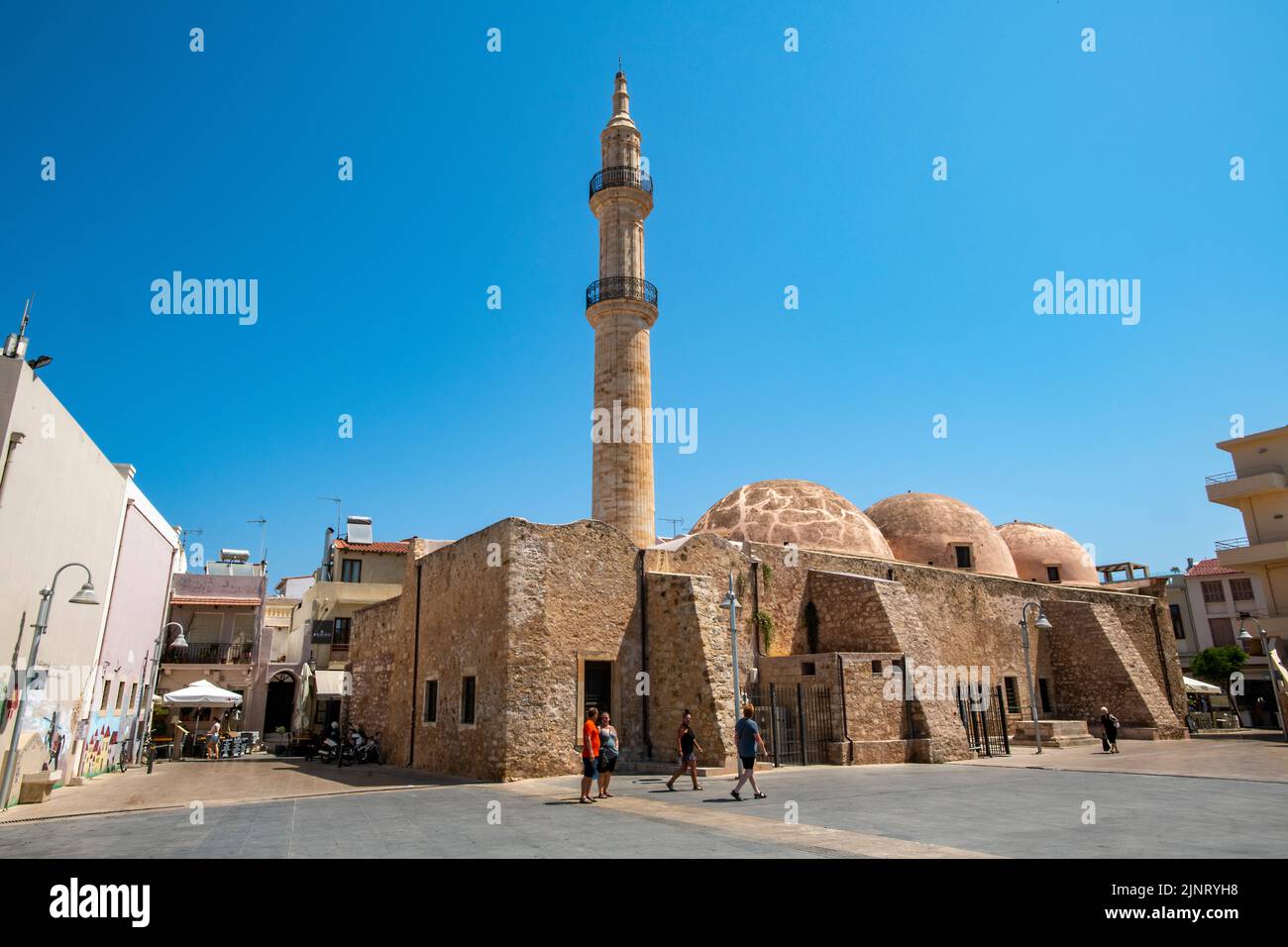 ancient mosque on harbourside with lighthouse at port entrance in