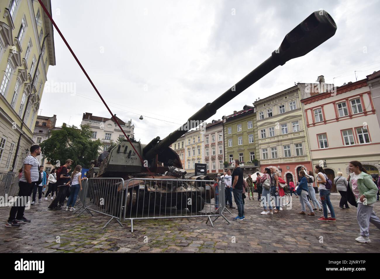 People look at a Russian self-propelled artillery installation at an exhibition of destroyed Russian equipment in Lviv. Organised by the Ukrainian government, this exhibition will be in the centre of Lviv until the end of summer. Then it will be moved to the countries of North America. The idea is to expose the crimes that the Russian occupiers committed on Ukrainian territory. Stock Photo