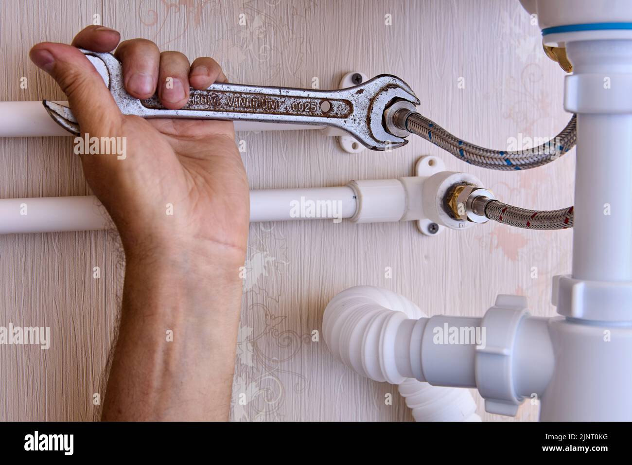 Connecting faucet to water supply using flexible braided hoses, plumber