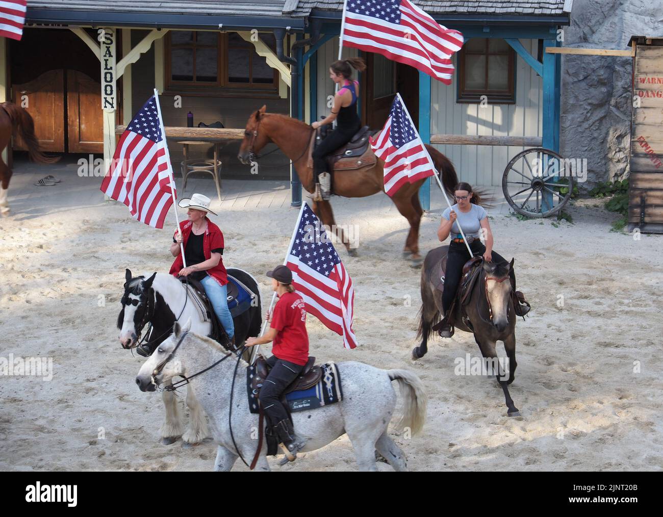 Participants of the Pullman City Equestrian Theater at the rehearsal of the performance. They are holding American flags. Stock Photo