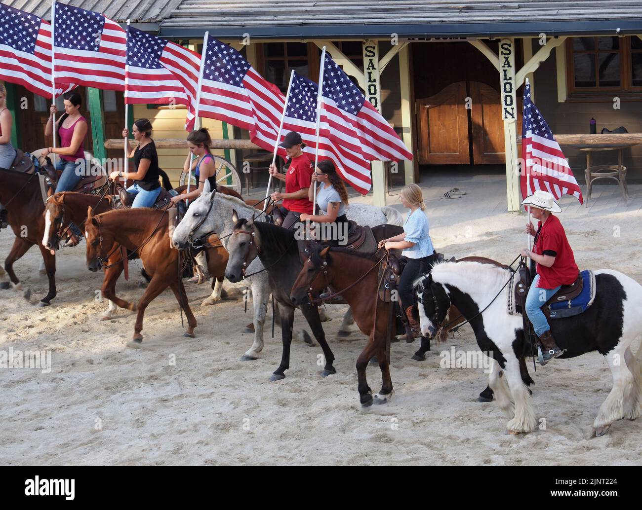 Participants of the Pullman City Equestrian Theater at the rehearsal of the performance. They are holding American flags. Stock Photo