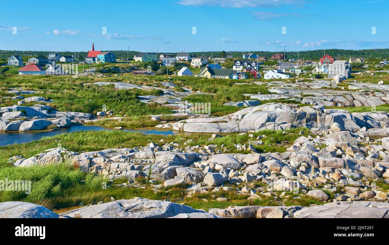 Peggy's Cove is a small fishing village on the mainland of Nova Scotia.  Home to the iconic Peggy's Cove Lighthouse it welcomes almost 1 million visto Stock Photo