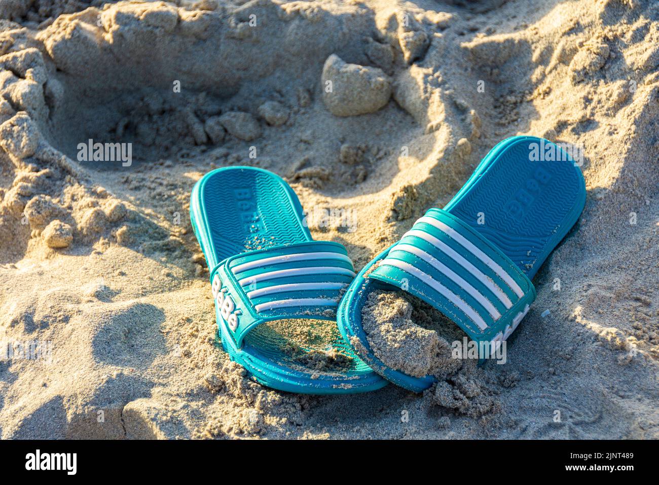 A pair of plastic, beach sandals on the sand, Varadero Beach, Cuba. Stock Photo