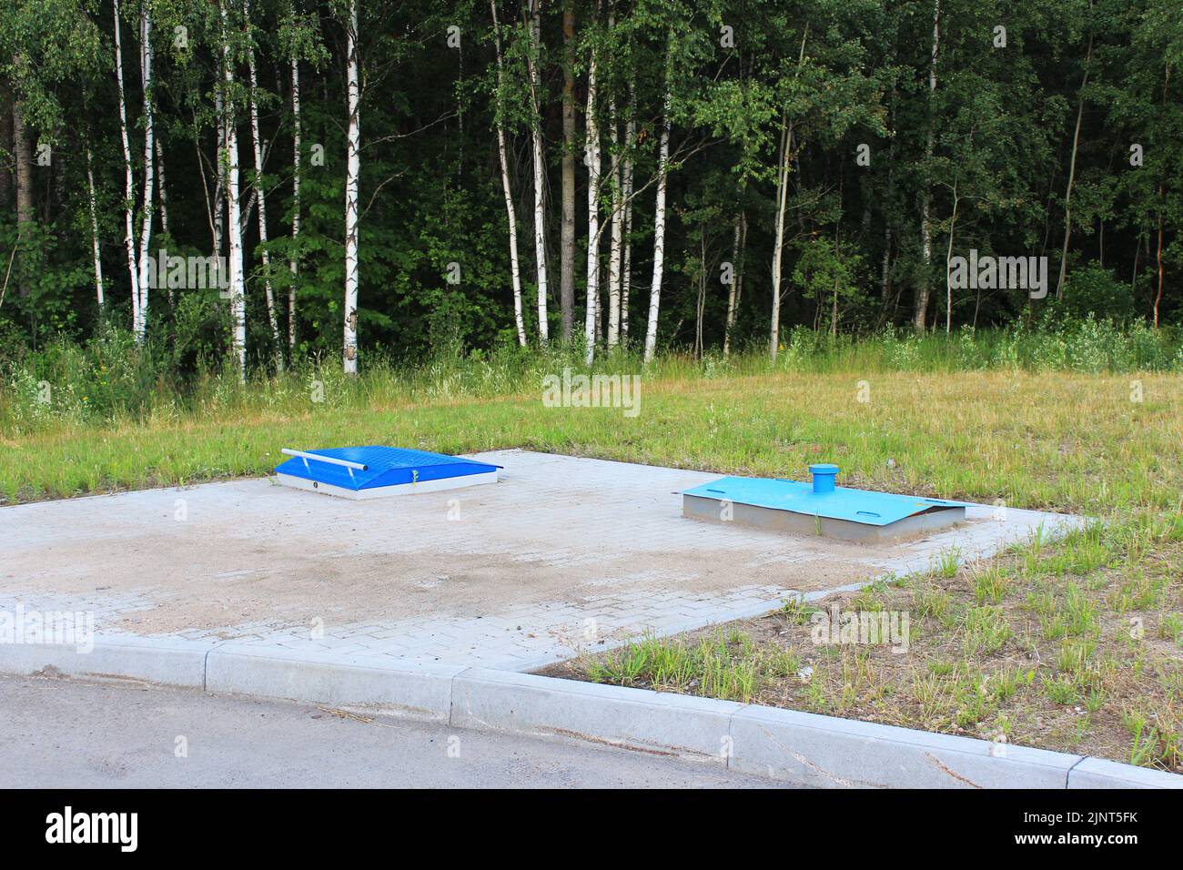 Two underground fuel storage tanks on the territory of a gas station, equipped platform. Stock Photo
