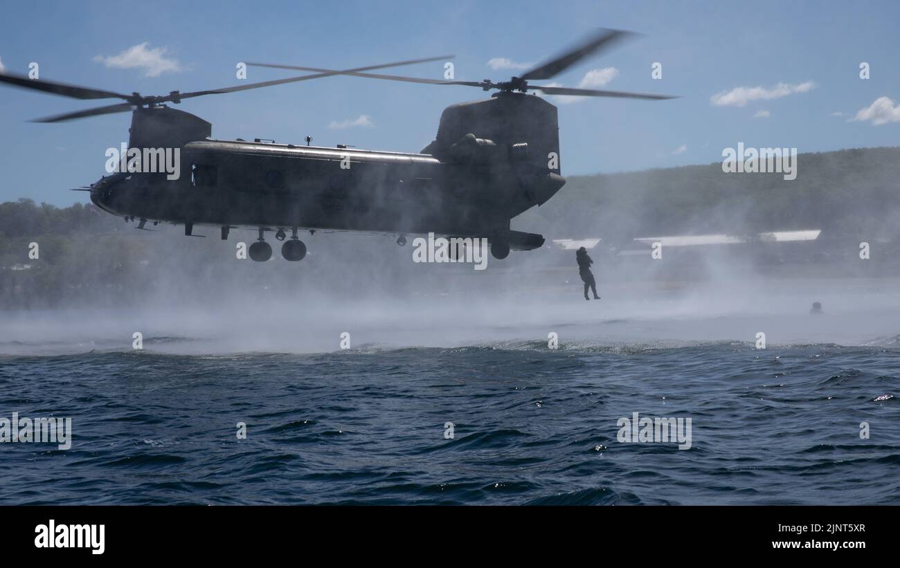 US Army soldiers, assigned to 20th Special Forces Group, Alabama National Guard, jump out of CH-47 Chinook during Helocast training as part of exercise Northern Strike 22-2 at Camp Grayling, Mich., Aug. 11, 2022. Northern Strike is designed to challenge approximately 7,400 service members with multiple forms of training that advance interoperability across multicomponent, multinational and interagency partners. Stock Photo