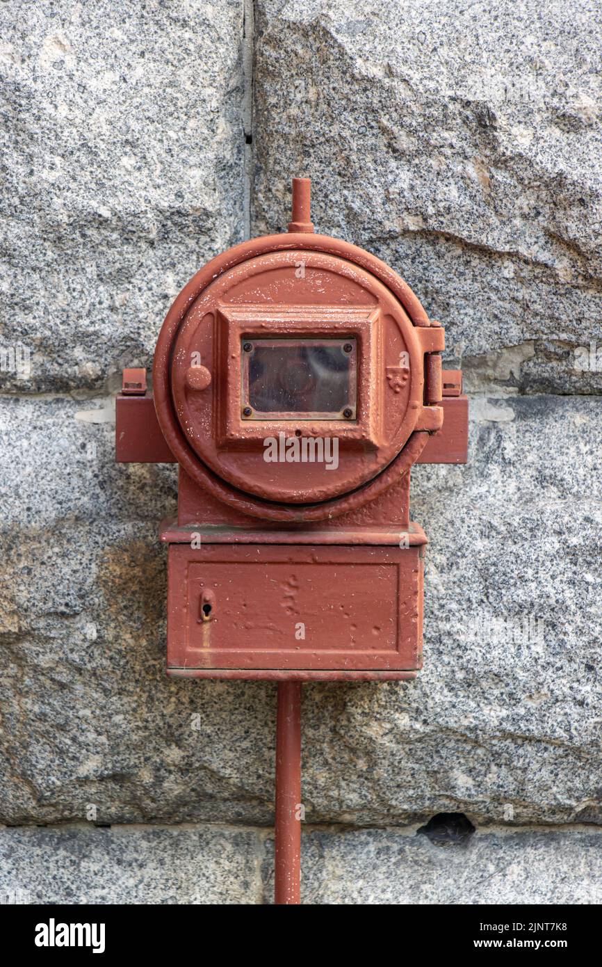 Old fire alarm on outdoor wall Stock Photo