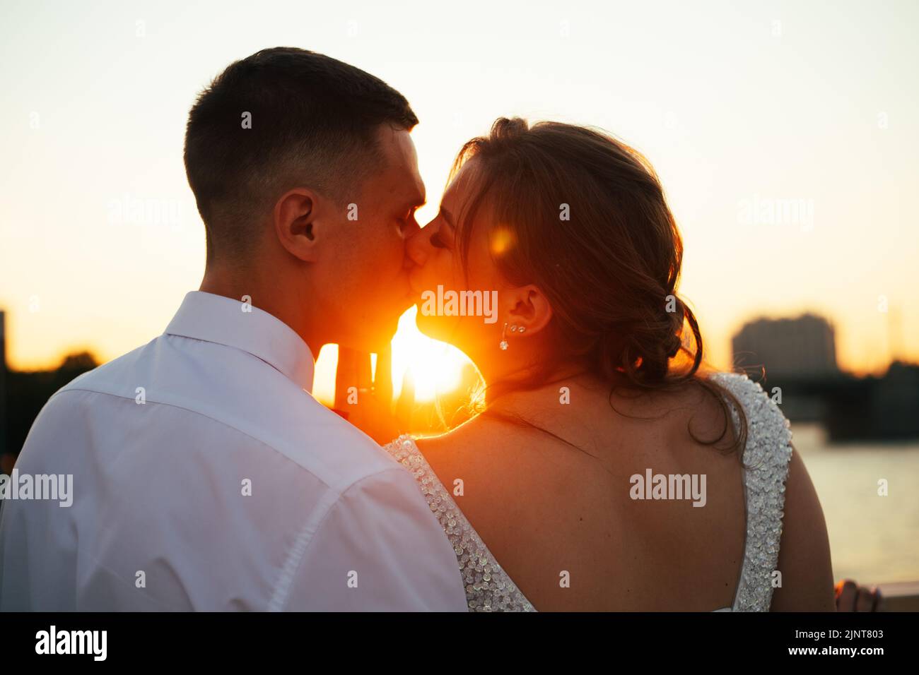 A Kiss Of The Bride And Groom At Sunset Wedding Article A Happy A Kiss Of The Bride And Groom At Sunset Wedding Article A Happy