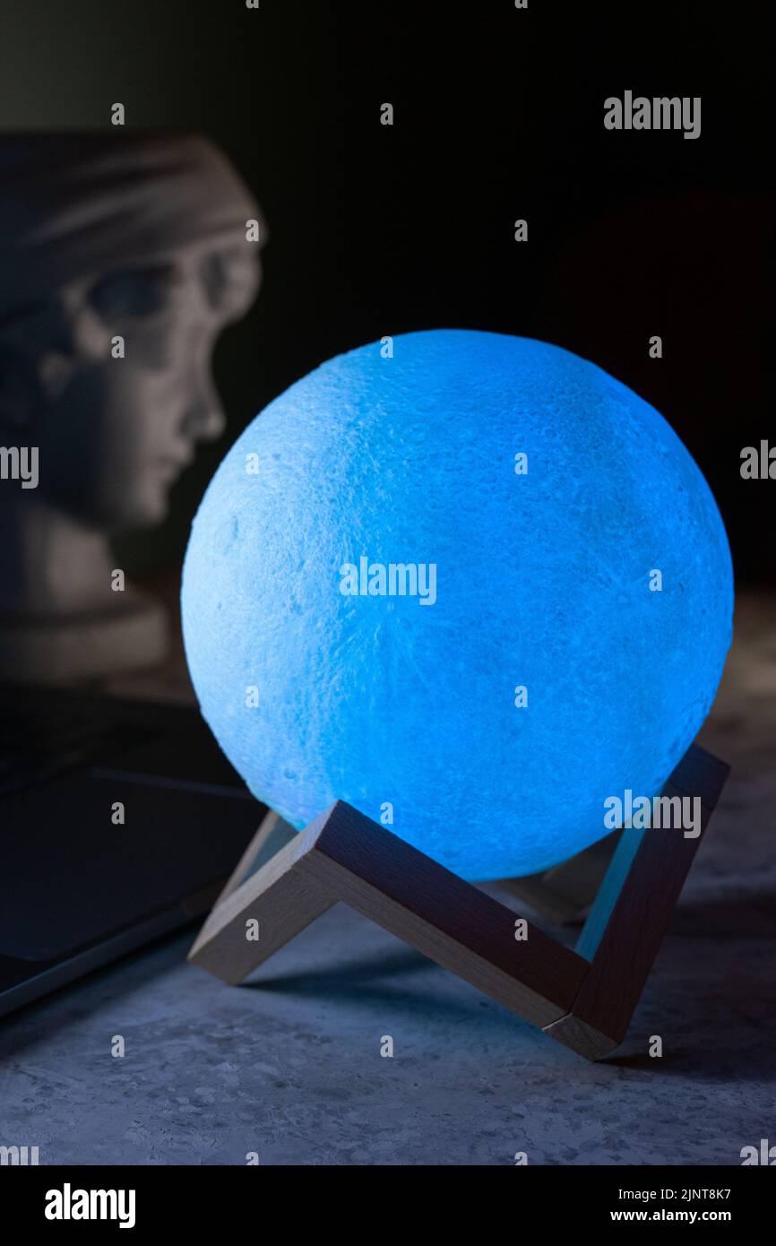 Light the lamp on the desktop. A modern table lamp illuminates the