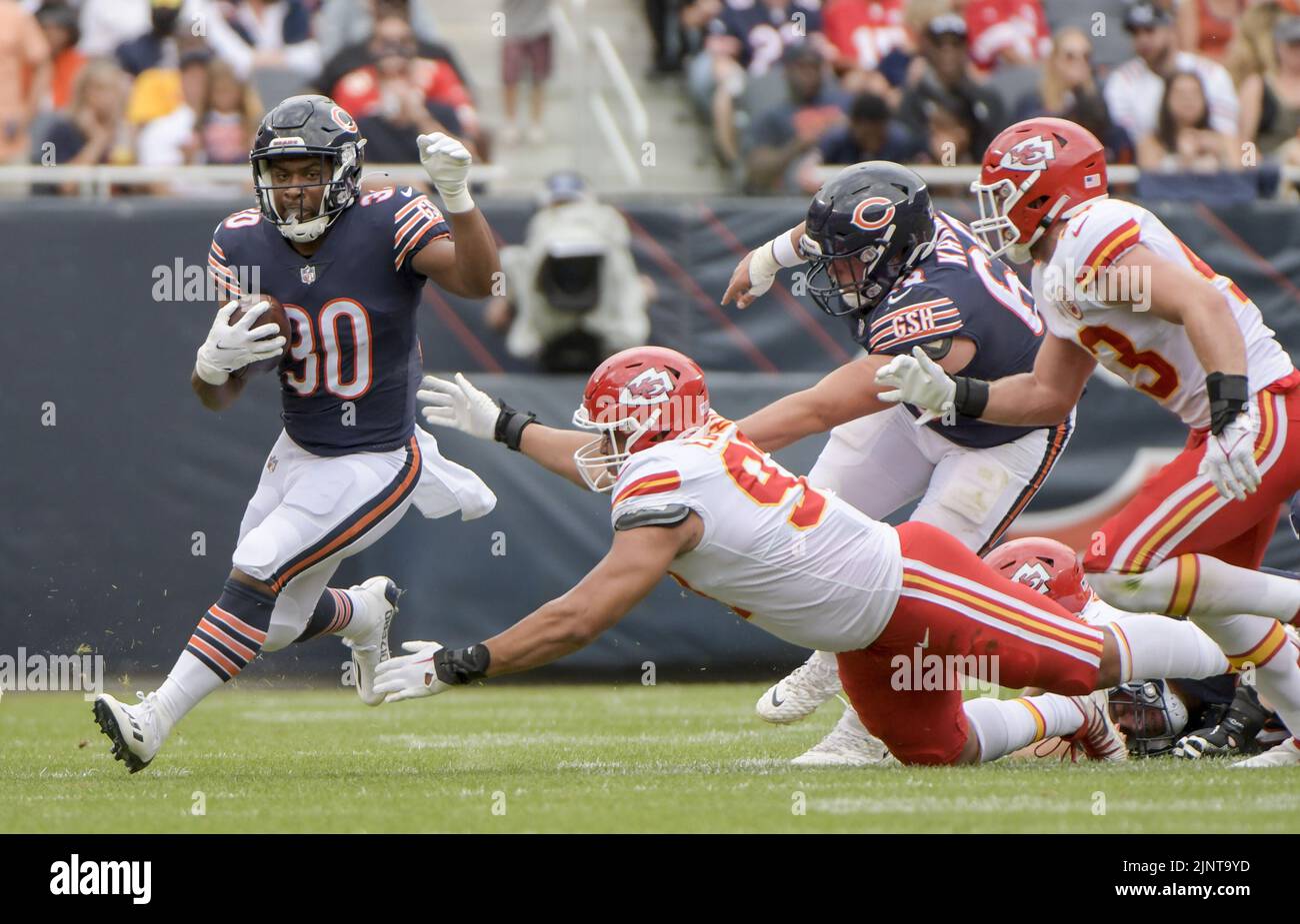 Chicago, United States. 13th Aug, 2022. Chicago Bears running back De'Montre Tuggle (30) avoids the tackle from Kansas City Chiefs defensive end Austin Edwards (97) during the fourth quarter of a preseason game at Soldier Field in Chicago on Saturday, August 13, 2022. The Bears won 19-14. Photo by Mark Black/UPI Credit: UPI/Alamy Live News Stock Photo