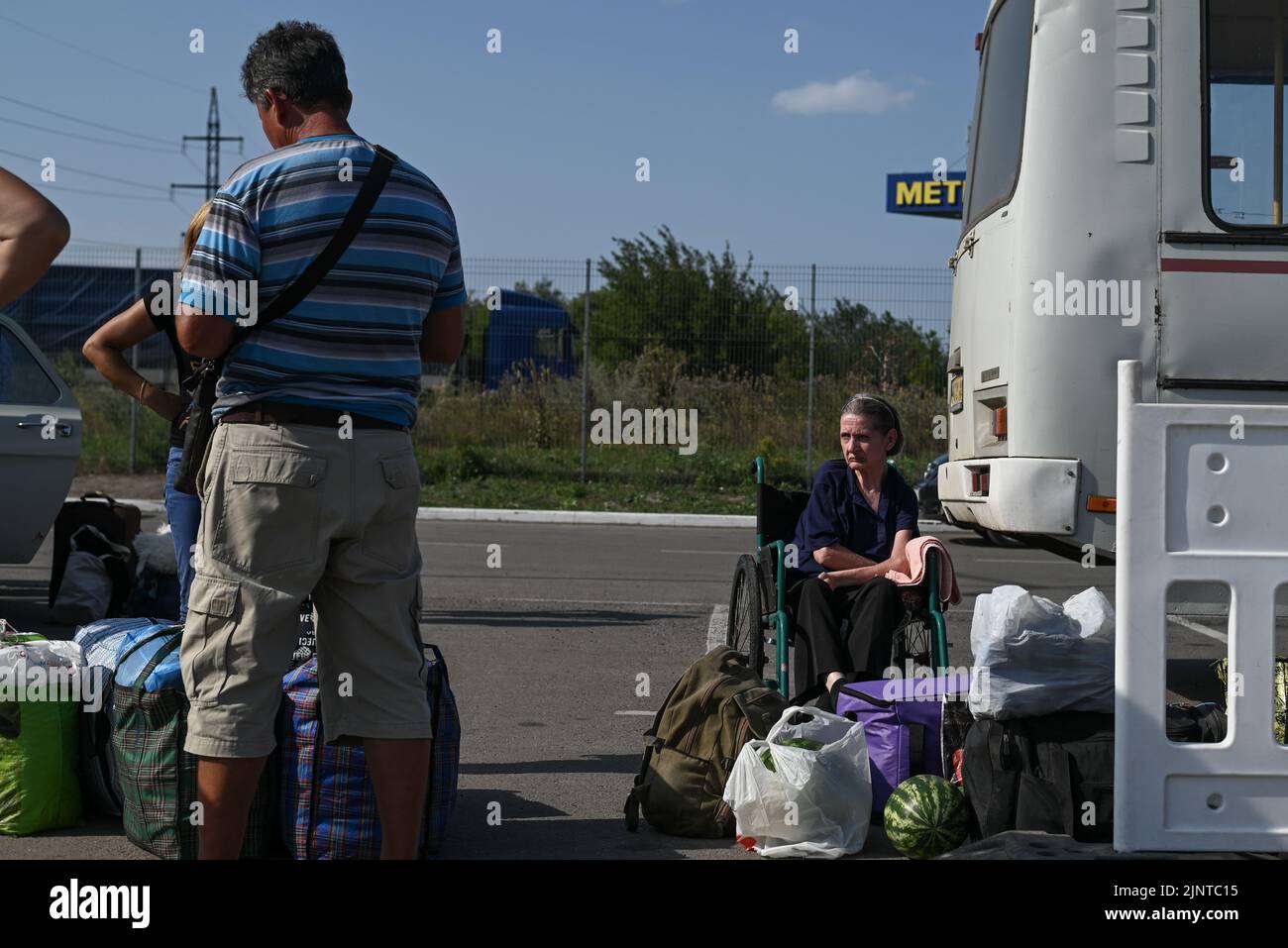 Ukraine. 13th Aug, 2022. Natalia, a wheelchair bound internally displaced person from the Russian occupied village of Rozivka sits among her belongings after disembarking from a bus on August 13th, 2022. Internally displaced persons from Russian occupied Ukraine arrive to an intake center in the city of Zaporizhia, as shelling intensifies around the region. Zaporizhia, Ukriane. (Photo by Justin Yau/ Credit: Sipa USA/Alamy Live News Stock Photo