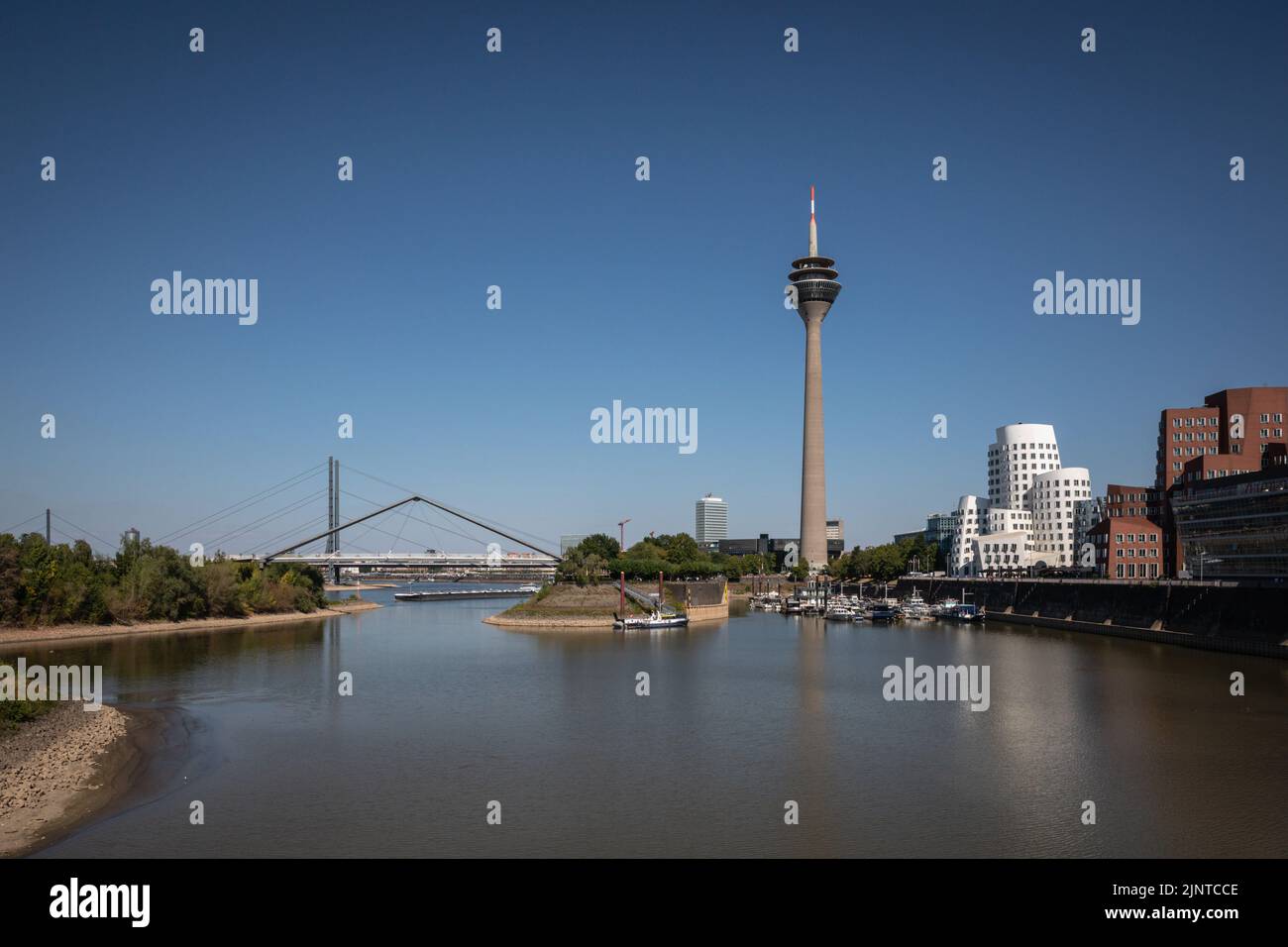 Düsseldorf, NRW, Germany, 13th Aug 2022. Temperatures again reached 32-35 degrees for the fourth consecutive day in the capital of NRW. The River Rhine, one of the busiest inland waterways in the world, has been strongly affected by the ongoing drought and resulting low water levels, caused by prolonged heat of up to 40 degrees and very little rain in the last few weeks. The shipping lane has narrowed down considerably, slowing down traffic, most vessels have also had to considerably reduce their freight weight, leading to supply issues and higher shipping prices. Stock Photo